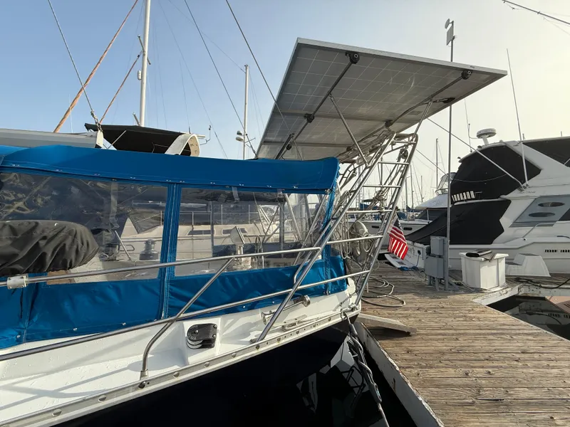 Slide: The Image of Beneteau Idylle 15.50 sailboat, 1986 model, docked with solar panels and blue canopy. - 6