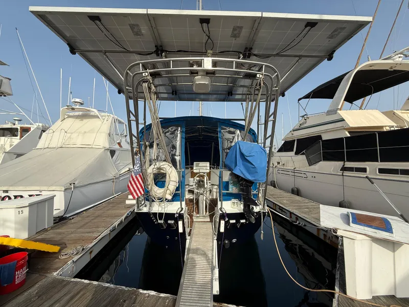 Slide: The Image of Beneteau Idylle 15.50 sailboat, 1986 model, docked with solar panels and American flag. - 7