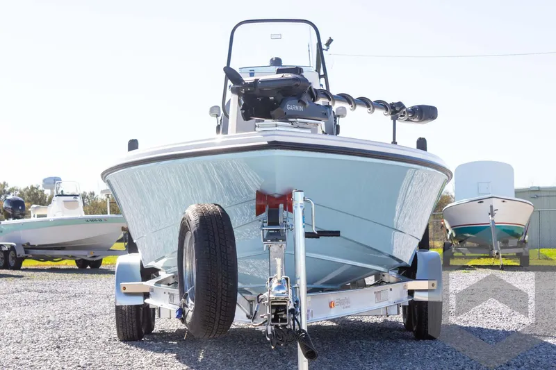 Slide: The Image of 2025 Pathfinder 2300 HPS boat on trailer, front view, parked on gravel. - 12