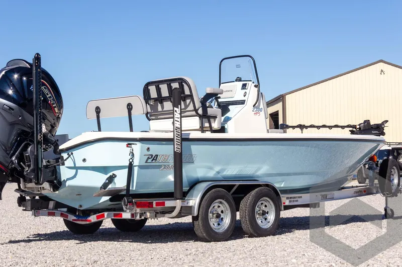 Slide: The Image of 2025 Pathfinder 2300 HPS boat on trailer, parked outdoors. - 15
