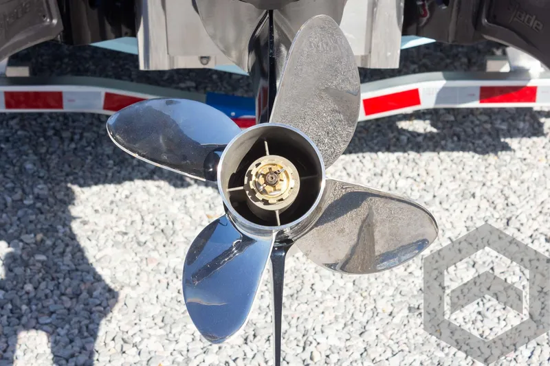 Slide: The Image of Close-up of a 2025 Pathfinder 2300 HPS boat propeller on gravel background. - 26