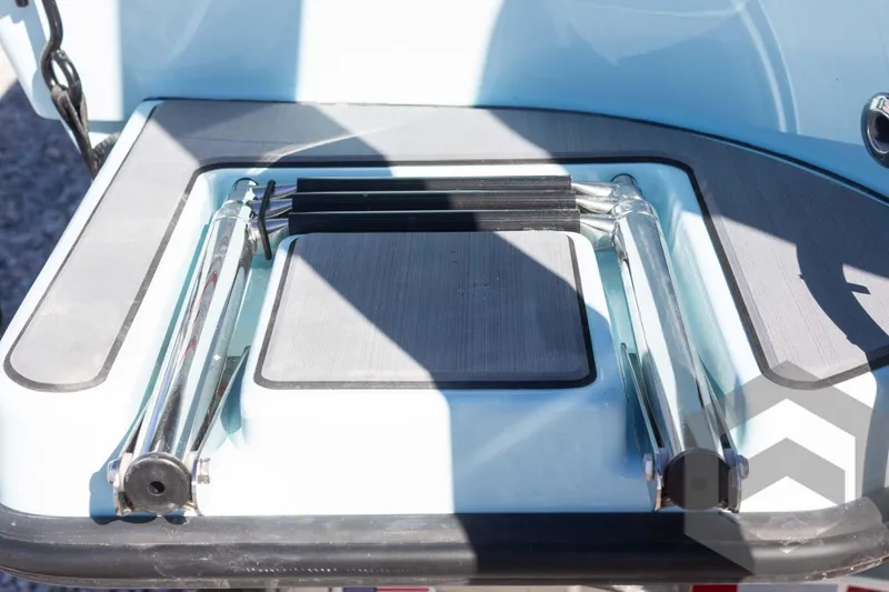 Slide: The Image of 2025 Pathfinder 2300 HPS boat ladder, folded on deck, in sunlight. - 29