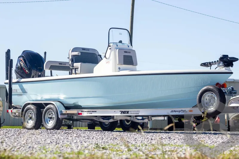 Slide: The Image of 2025 Pathfinder 2300 HPS boat on trailer, light blue hull, outdoor setting. - 3