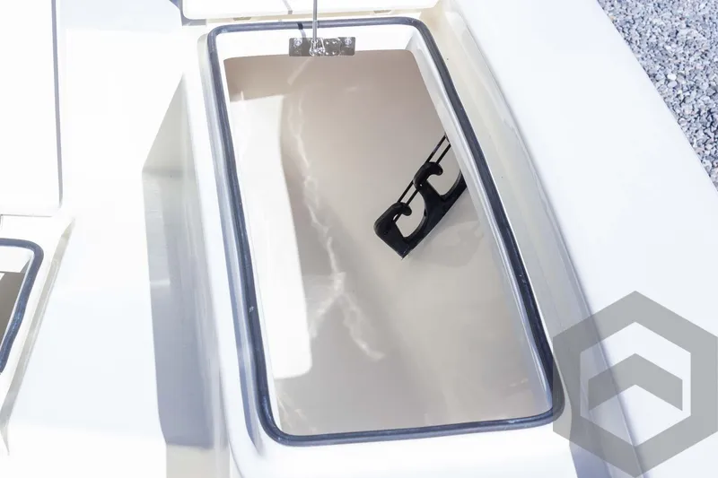 Slide: The Image of Pathfinder 2300 HPS 2025 boat storage compartment with open lid and latch. - 35