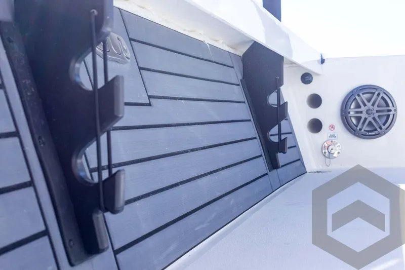 Slide: The Image of 2025 Pathfinder 2300 HPS boat interior with speaker and rod holders. - 47