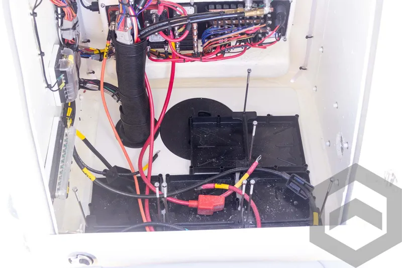 Slide: The Image of Pathfinder 2300 HPS 2025 boat wiring and battery compartment with cables and connectors. - 49