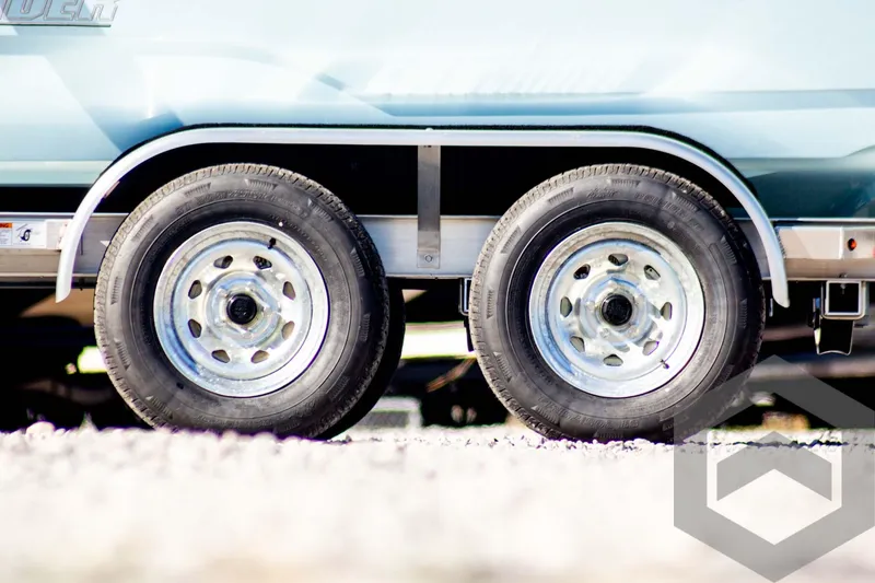Slide: The Image of Close-up of 2025 Pathfinder 2300 HPS trailer wheels on gravel. - 5