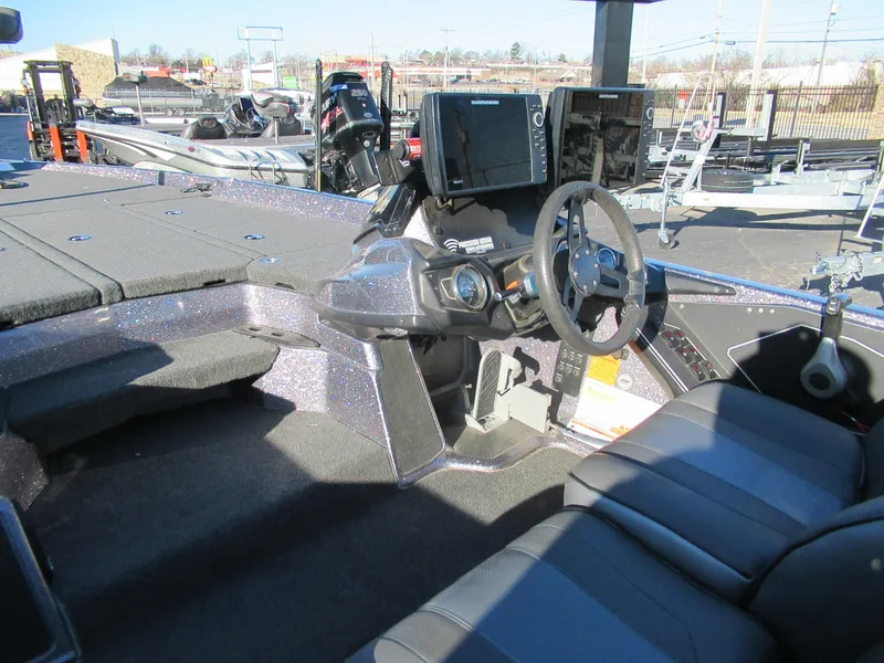 Slide: The Image of 2021 Skeeter ZXR 21 boat interior with steering wheel and control panel. - 2