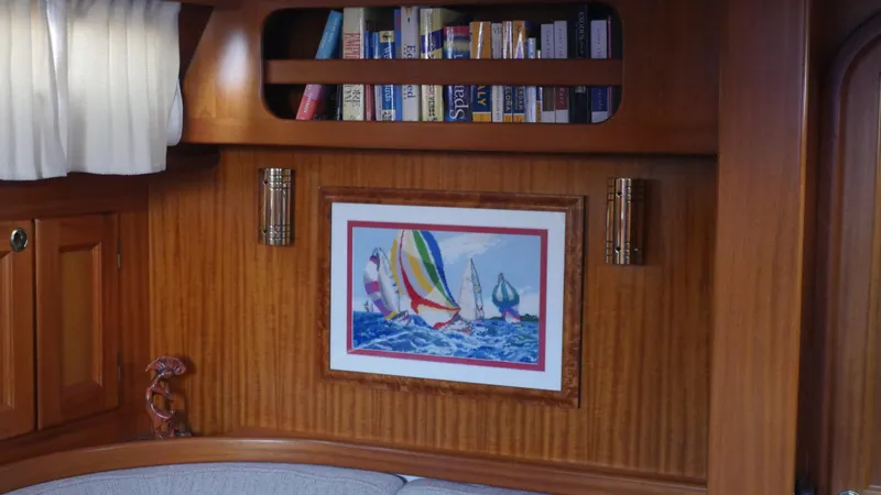 Slide: The Image of Interior of 2001 Malo 43 yacht with bookshelf and nautical artwork. - 15