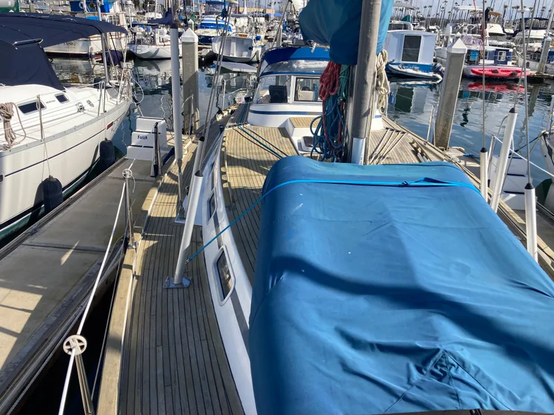Slide: The Image of Sailboat Malo 43, 2001 model, docked at marina with blue cover. - 34