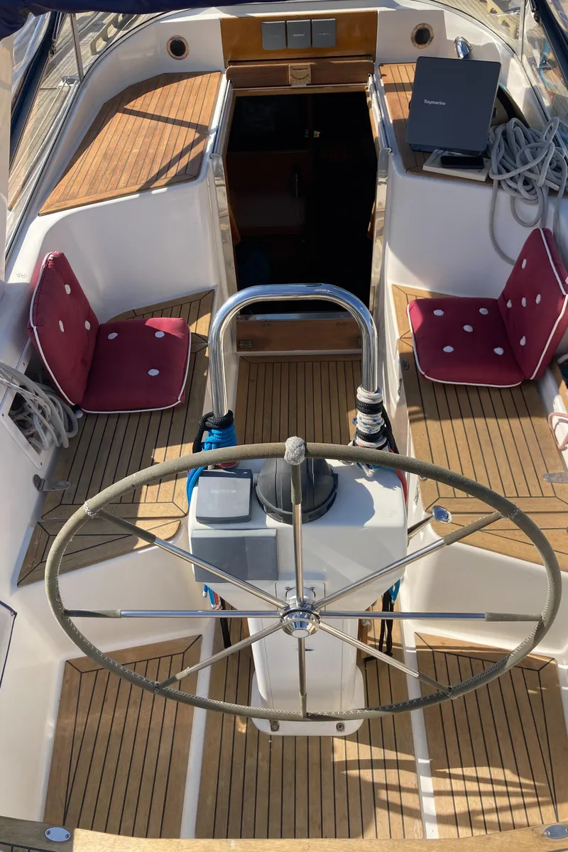 Slide: The Image of Sailboat Malo 43, 2001 model, featuring a wooden deck and steering wheel in the cockpit. - 35