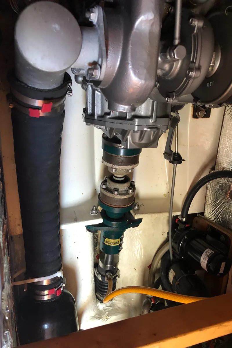 Slide: The Image of Engine compartment of a 2001 Malo 43 boat, showing mechanical components and hoses. - 51