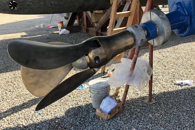 Slide: The Image of Sailboat propeller of a 2001 Malo 43 on gravel surface, undergoing maintenance. - 54