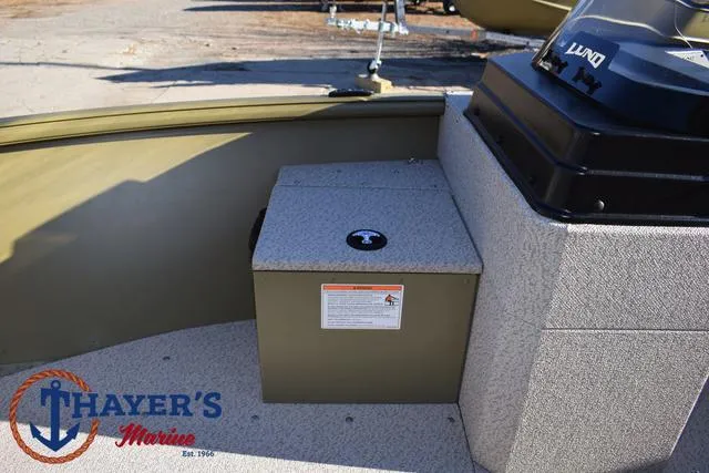 Slide: The Image of 2025 Lund 1875 Alaskan SS boat interior with storage compartment, Thayer's Marine logo visible. - 15