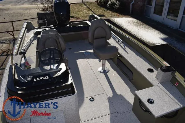 Slide: The Image of 2025 Lund 1875 Alaskan SS boat interior with seating and console, displayed at Thayer's Marine. - 21