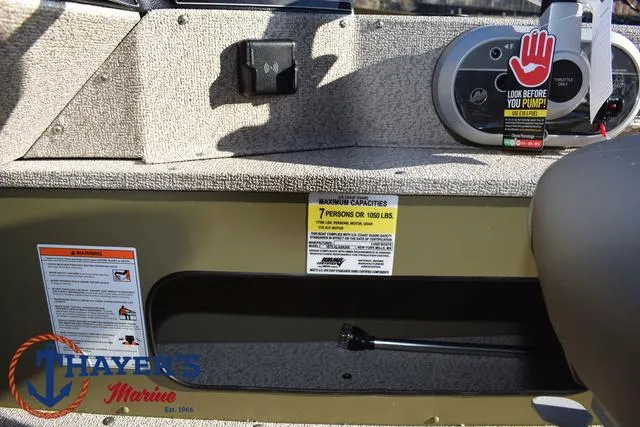 Slide: The Image of 2025 Lund 1875 Alaskan SS boat interior with capacity warning label and control panel. - 30