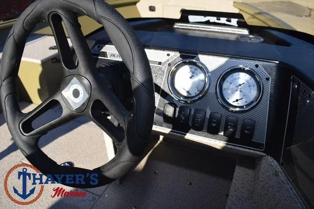 Slide: The Image of 2025 Lund 1875 Alaskan SS boat dashboard with steering wheel and gauges. - 31