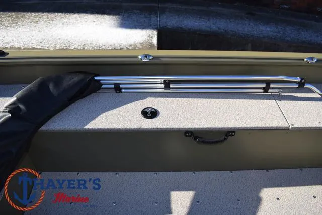 Slide: The Image of 2025 Lund 1875 Alaskan SS boat interior with storage compartment and railing. - 33