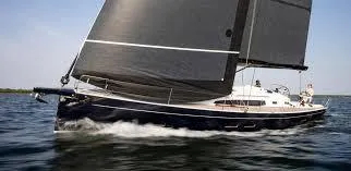 Slide: The Image of 2026 J Boats J/45 sailing yacht gliding on open water with sleek black sails. - 3