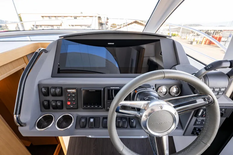 Slide: The Image of 2024 Nimbus 405 Flybridge helm with modern controls and steering wheel. - 10