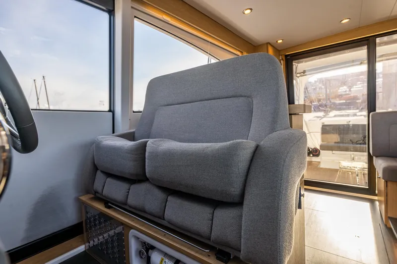 Slide: The Image of Luxurious interior of 2024 Nimbus 405 Flybridge yacht with plush seating. - 11