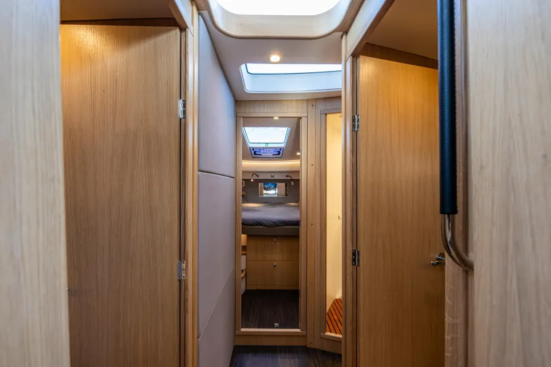 Slide: The Image of Interior of 2024 Nimbus 405 Flybridge yacht, featuring wooden doors and cozy cabin space. - 13