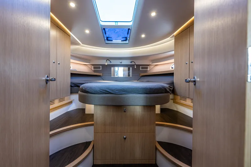 Slide: The Image of Luxurious interior of 2024 Nimbus 405 Flybridge yacht with modern wood finish and ambient lighting. - 14
