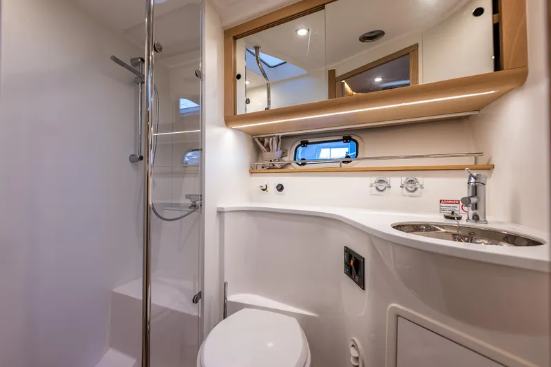Slide: The Image of Luxurious bathroom in 2024 Nimbus 405 Flybridge yacht with modern fixtures and elegant design. - 18