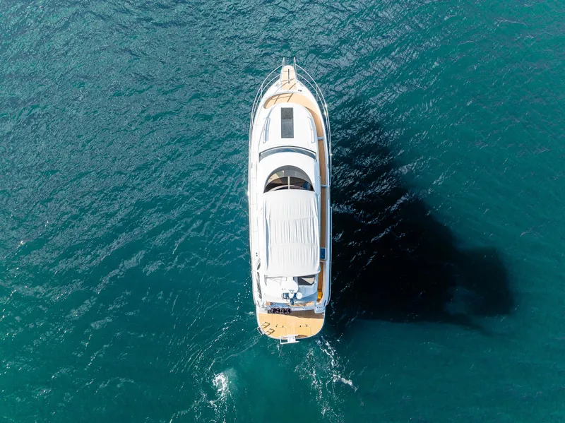 Slide: The Image of Aerial view of 2024 Nimbus 405 Flybridge yacht on blue ocean water. - 24