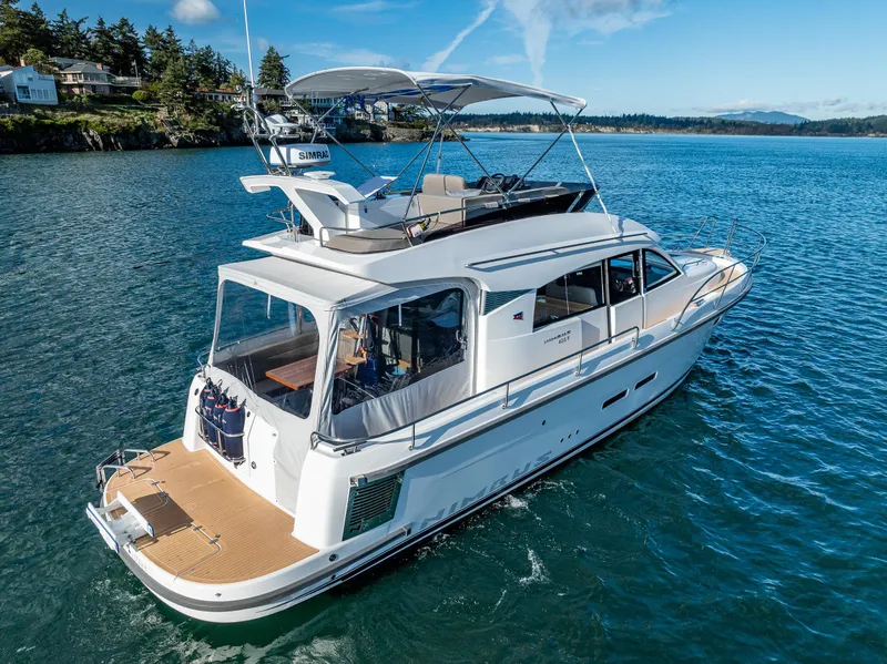 Slide: The Image of 2024 Nimbus 405 Flybridge yacht cruising on serene blue waters. - 3