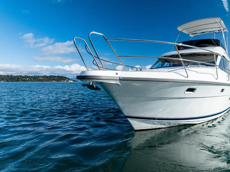 Slide: The Image of 2024 Nimbus 405 Flybridge yacht cruising on a clear blue sea. - 39