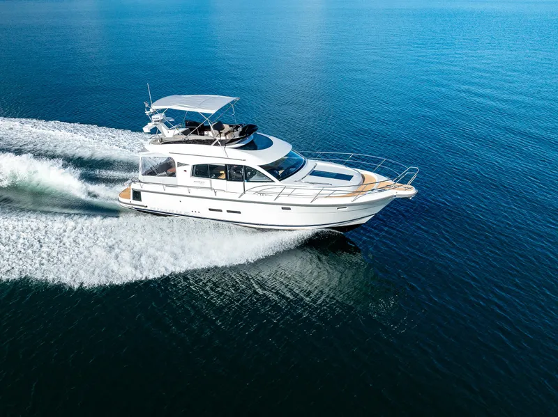 Slide: The Image of 2024 Nimbus 405 Flybridge cruising on open water, showcasing sleek design and performance. - 47