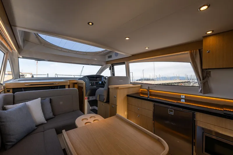 Slide: The Image of Luxurious interior of 2024 Nimbus 405 Flybridge yacht with modern kitchen and seating area. - 7