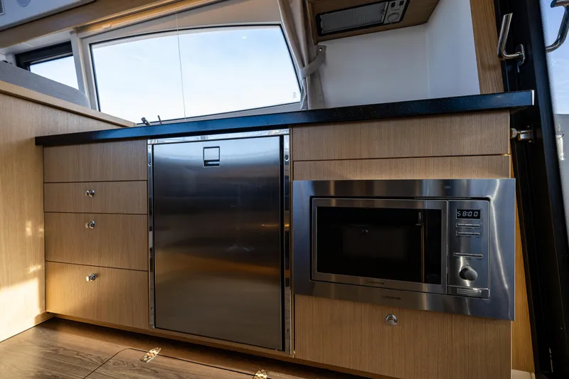Slide: The Image of Modern kitchen in 2024 Nimbus 405 Flybridge yacht with stainless steel appliances. - 8