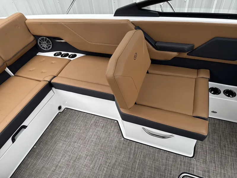 Slide: The Image of 2025 Cobalt CS23 boat interior with tan leather seating and modern design. - 12