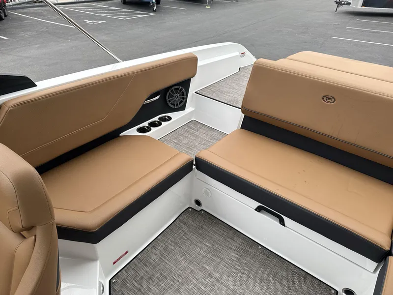 Slide: The Image of 2025 Cobalt CS23 boat interior with tan seating and cup holders. - 13