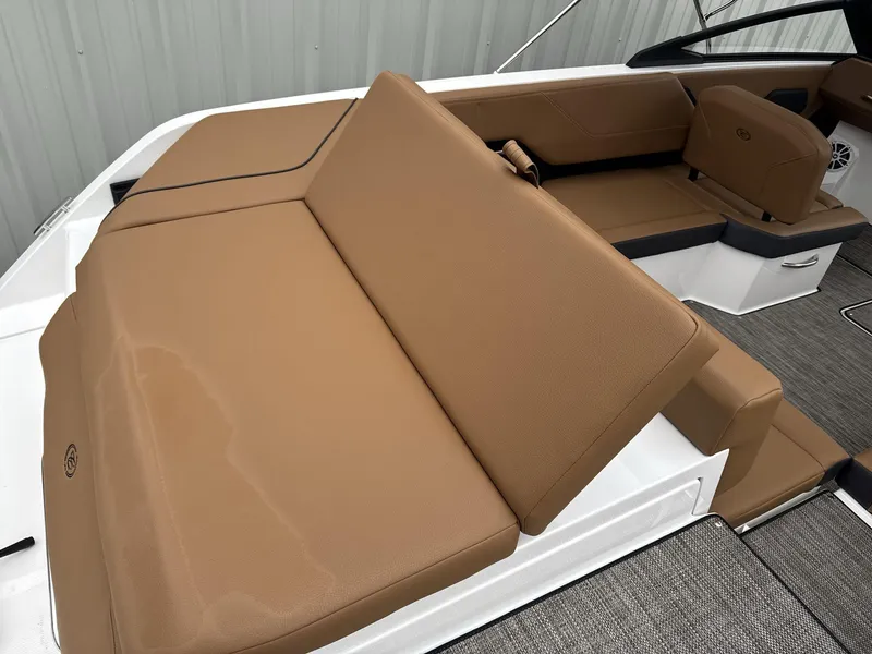 Slide: The Image of 2025 Cobalt CS23 boat interior with tan leather seating and modern design. - 14