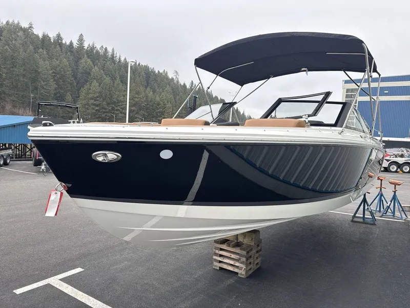 Slide: The Image of 2025 Cobalt CS23 boat displayed outdoors on a stand. - 3