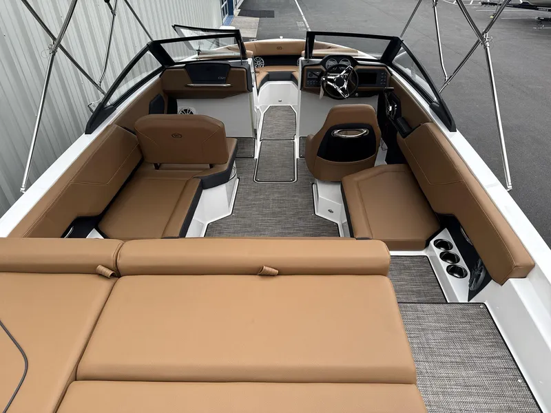 Slide: The Image of 2025 Cobalt CS23 boat interior with tan seating and modern dashboard. - 6