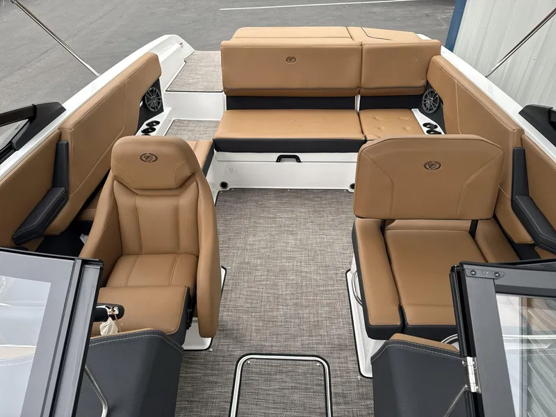 Slide: The Image of 2025 Cobalt CS23 boat interior with tan leather seating and modern design. - 8