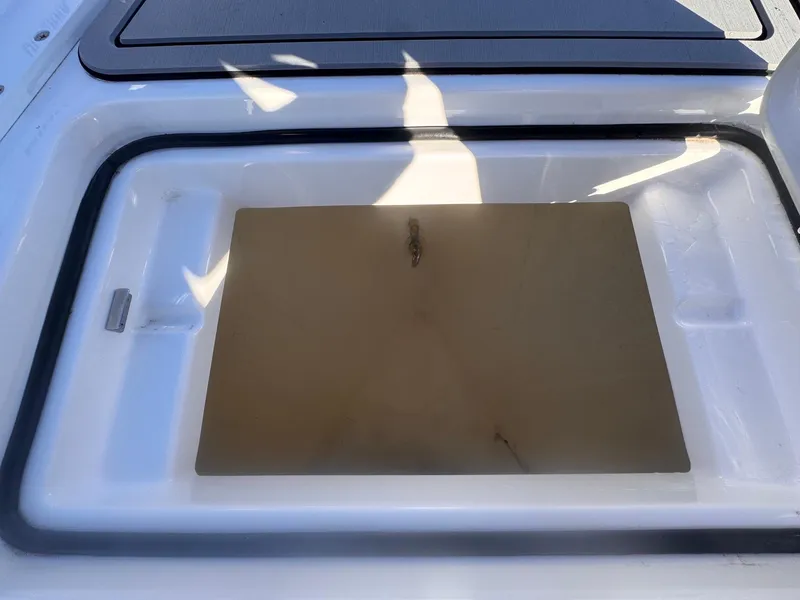 Slide: The Image of 2024 Aquasport 2200 Center Console storage compartment detail. - 12