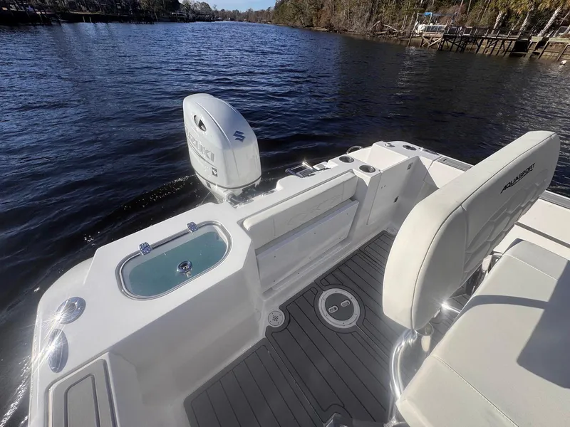 Slide: The Image of 2024 Aquasport 2200 Center Console boat on a calm river. - 15