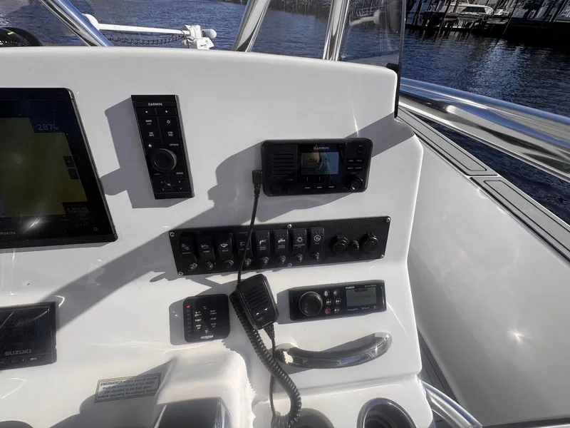 Slide: The Image of 2024 Aquasport 2200 Center Console dashboard with navigation and control systems. - 20