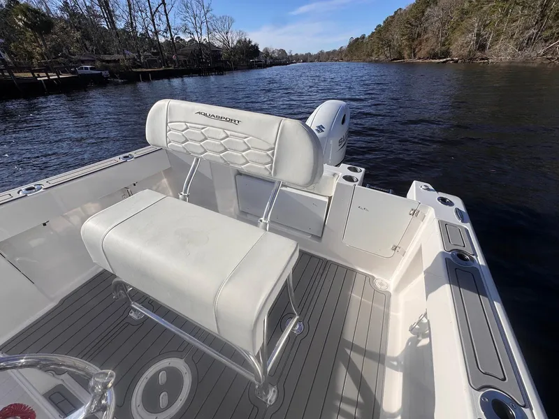 Slide: The Image of 2024 Aquasport 2200 Center Console boat on a scenic river. - 22