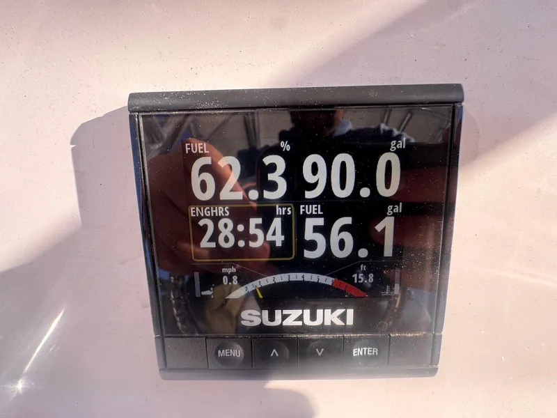 Slide: The Image of Suzuki fuel gauge on 2024 Aquasport 2200 Center Console, showing fuel levels and engine hours. - 31