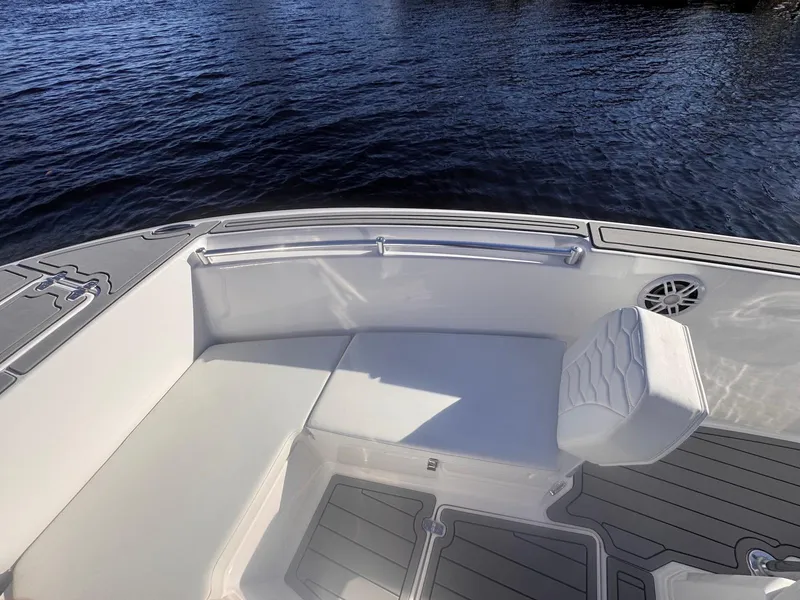 Slide: The Image of 2024 Aquasport 2200 Center Console boat interior with seating, on calm water. - 7