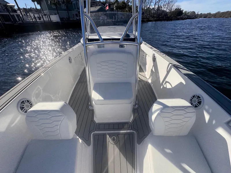 Slide: The Image of 2024 Aquasport 2200 Center Console boat on water, featuring sleek seating and modern design. - 9