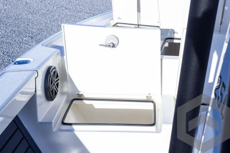 Slide: The Image of 2025 Pathfinder 2500 Hybrid boat storage compartment with open hatch and speaker. - 27