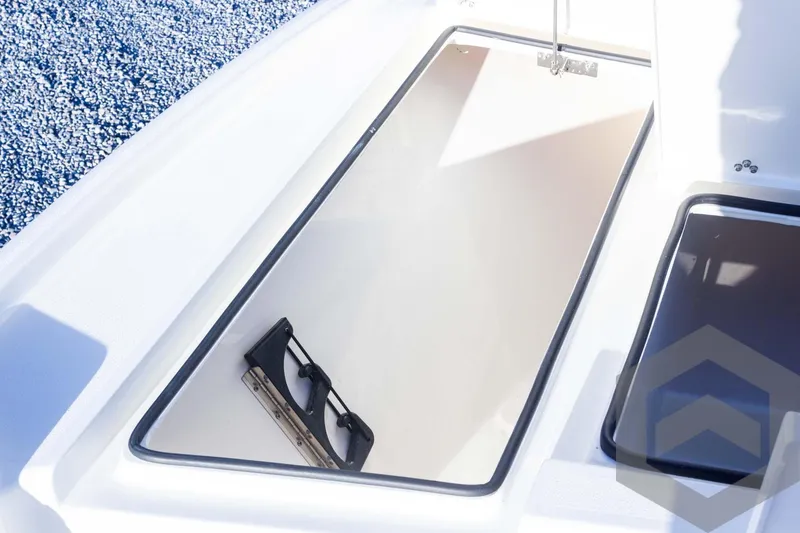 Slide: The Image of 2025 Pathfinder 2500 Hybrid boat storage compartment with sunglasses inside. - 28
