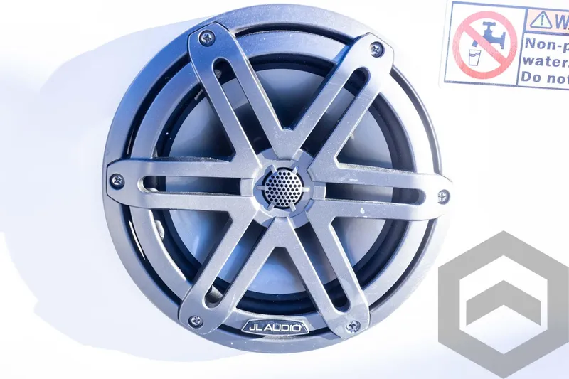 Slide: The Image of JL Audio speaker on Pathfinder 2500 Hybrid 2025 boat, with warning label nearby. - 36